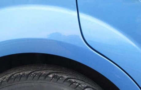 Side of blue car showing after scratch repair treatment