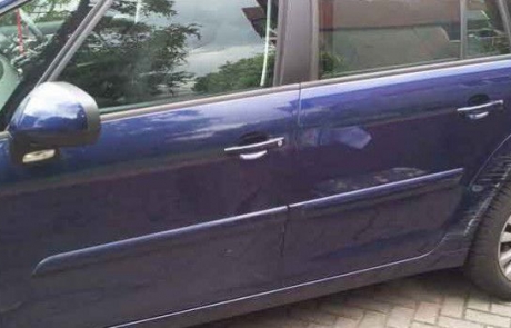 Scuff and dents on the side of blue Citroen Picasso