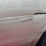 Close-up of damage on side of car