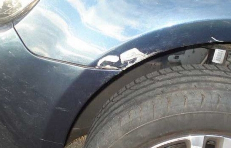 Close-up of dent repair on blue VW Golf